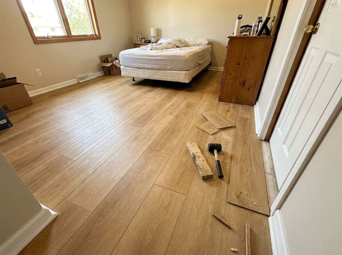 A bedroom with a new light oak plank floor
